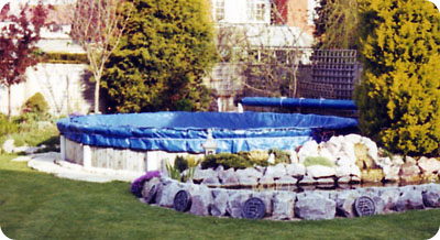 Winter debris cover on round above ground pool